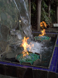 Natural gas fire pit with waterfall